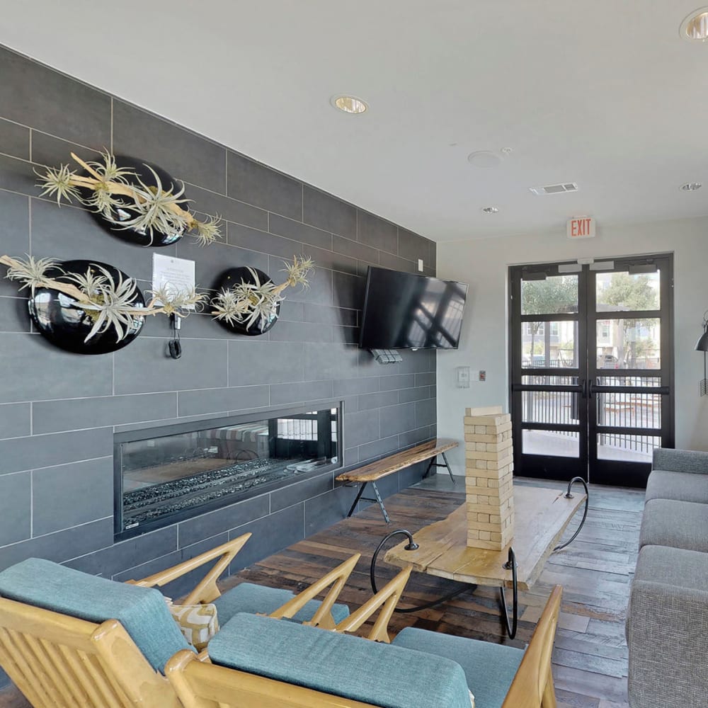 Lounge area in front of the fireplace in the resident clubhouse at Oaks Trinity in Dallas, Texas