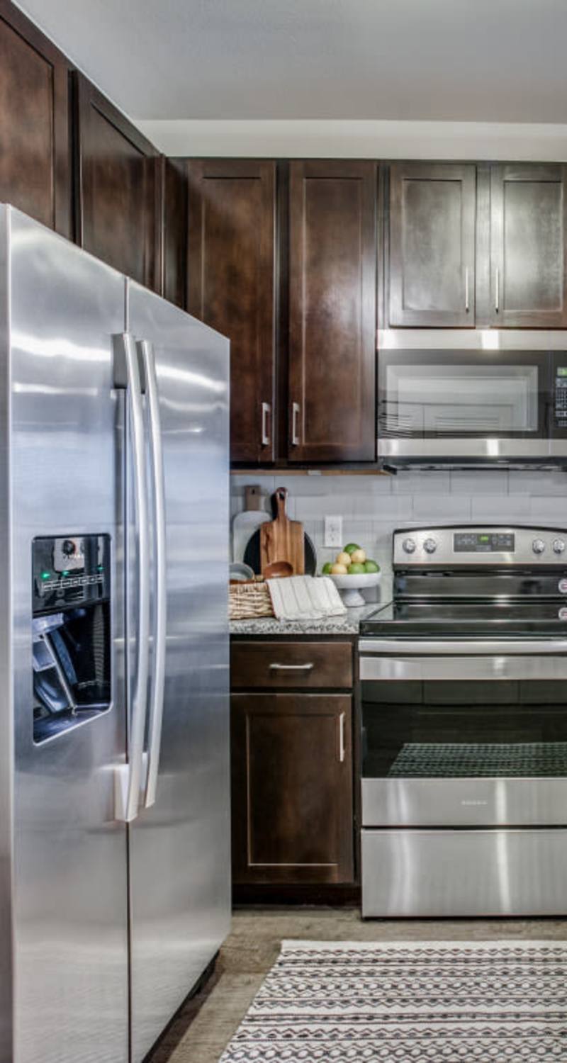 Modern kitchen with stainless-steel appliances at Silverstream in Katy, Texas