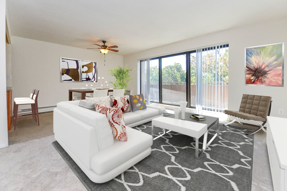 Living room and dining area opening onto a private patio at The Colonials Apartment Homes in Cherry Hill, New Jersey