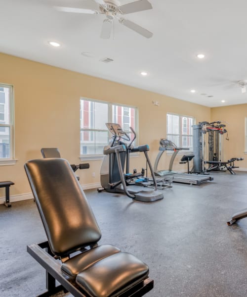 Cardio and weightlifting equipment at Huntsville Village Apartments in Huntsville, Texas
