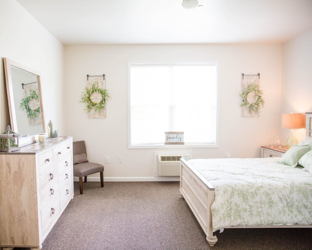 Spacious bedroom with wall art and dresser at Arcadian Cove in Richmond, Kentucky.