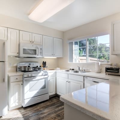 A kitchen with appliances in a home at Santo Terrace in San Diego, California