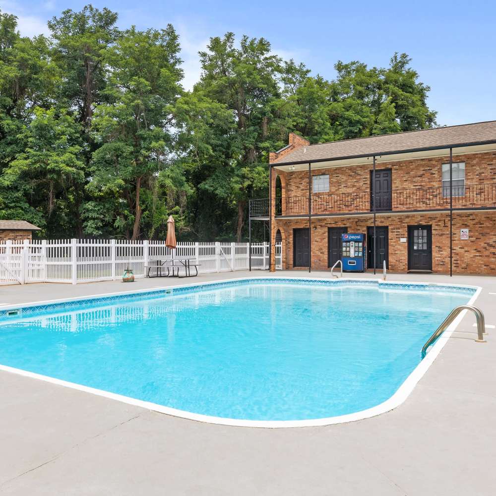 Charming property featuring a sparkling water pool and lush landscaping at Pecan Ridge in Vicksburg, Mississippi.
