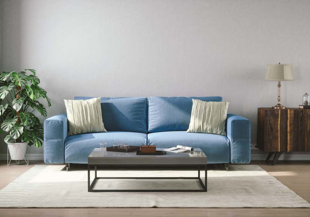 Cozy living room with modern blue sofa and stylish decor at Standard at Royal Lane in Dallas, Texas