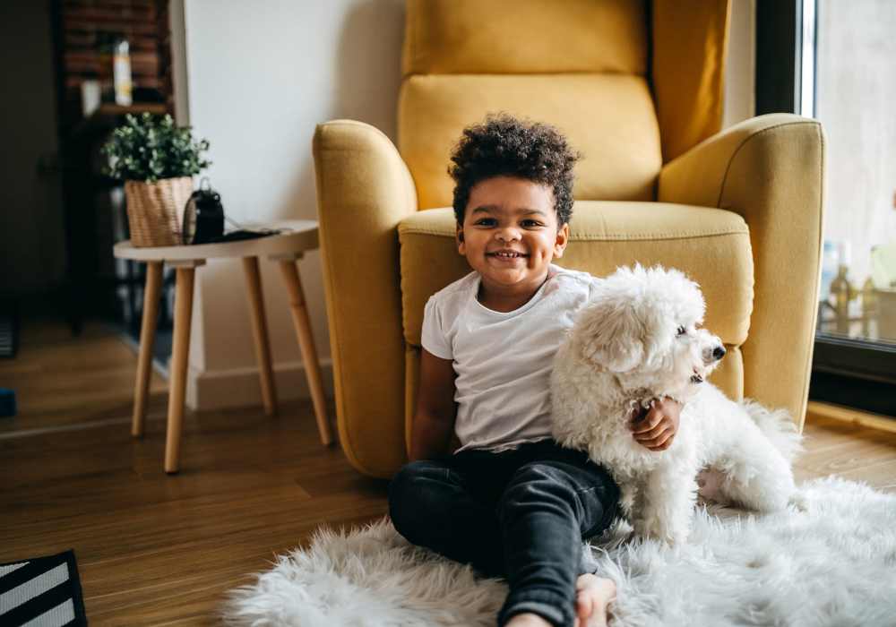 Young boy playing with puppy at pet-friendly community at Battleground North in Greensboro, North Carolina