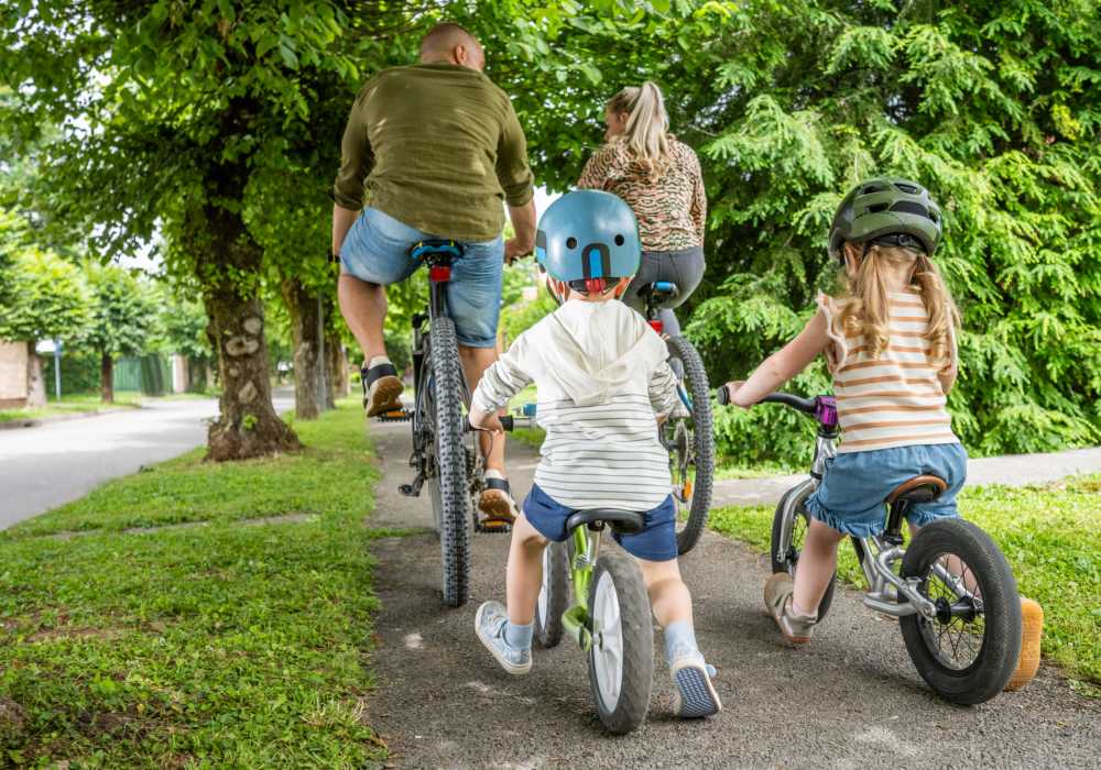 Children riding bicycles on a paved neighborhood trail near Unionville Station Townhomes in Hilton, New York