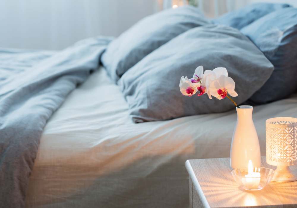 Cozy bedroom with soft linens and decor at Jefferson Manor Townhomes in Fairport, New York