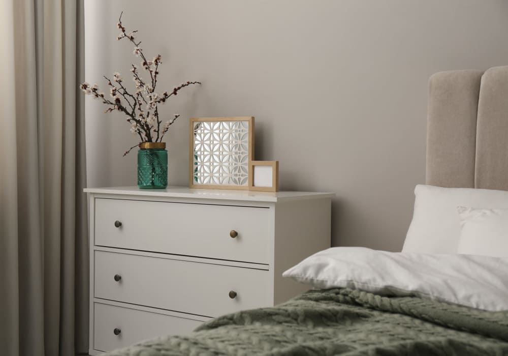 Stylish bedroom with minimalist decor and greenery at Jefferson Manor Townhomes in Fairport, New York