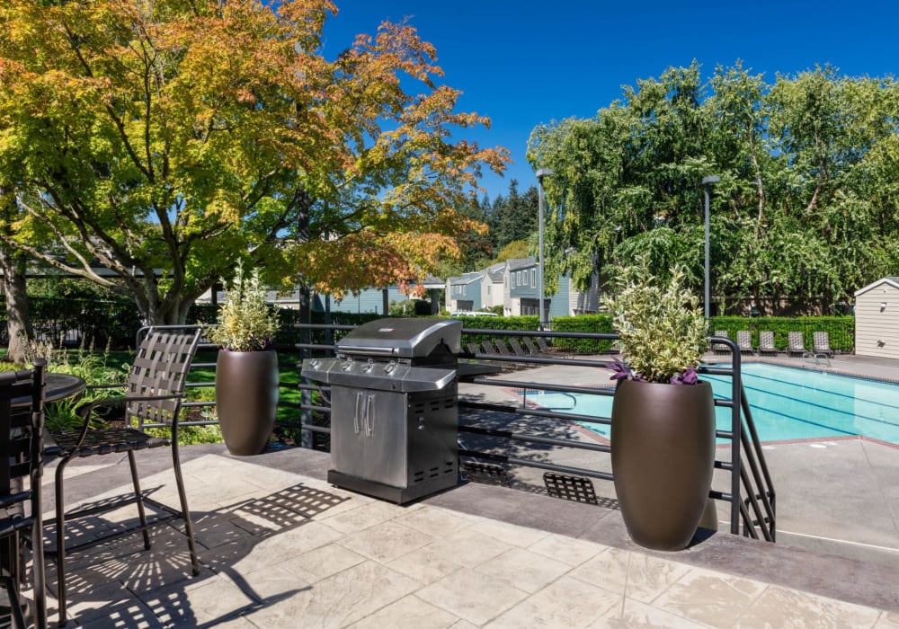 Barbecue and seating area alongside the large swimming pool at Haven at Golf Creek in Portland, Oregon