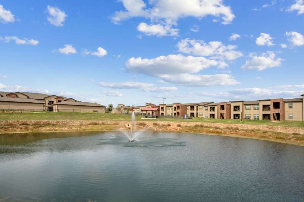 View of the lake and buildings at The BLVD in San Angelo, Texas