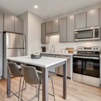 Model kitchen with grey accents at Marquee Living in Minneapolis, Minnesota