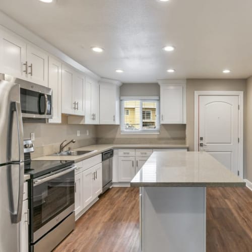 Kitchen with a large island with seating at Pentagon Apartments in Fremont, California