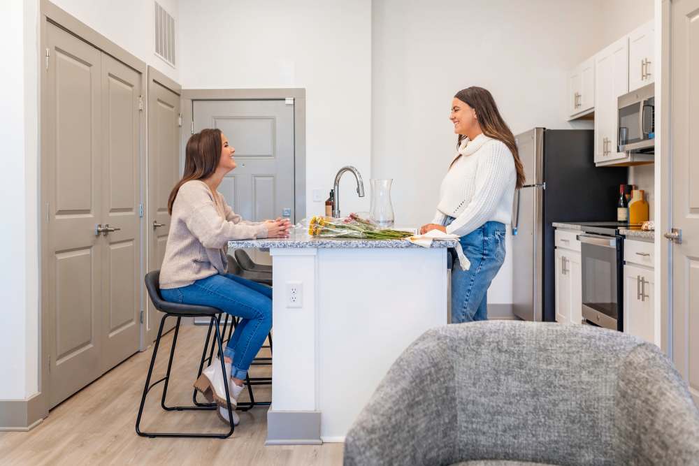 Residents in an apartment kitchen at The Waters at Promenade in Marrero, Louisiana