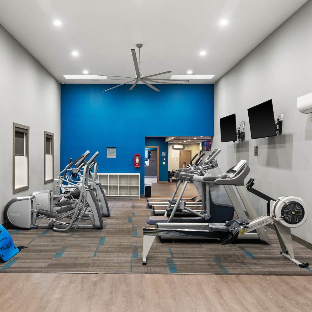 Fitness center with cardio equipment at Lodge at Madrona Ridge in Tacoma, Washington