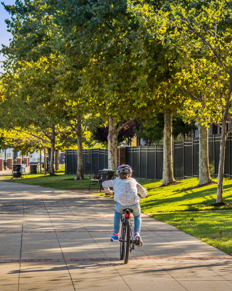 Girl biking on a path near Riverbend at Port Imperial in West New York, New Jersey