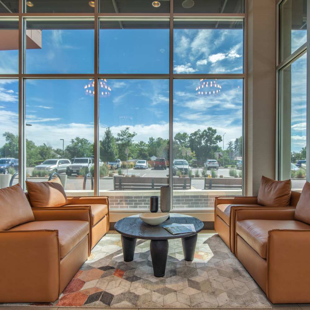 Community seating area with couch and large window at Park Place Olde Town Apartments in Arvada, Colorado