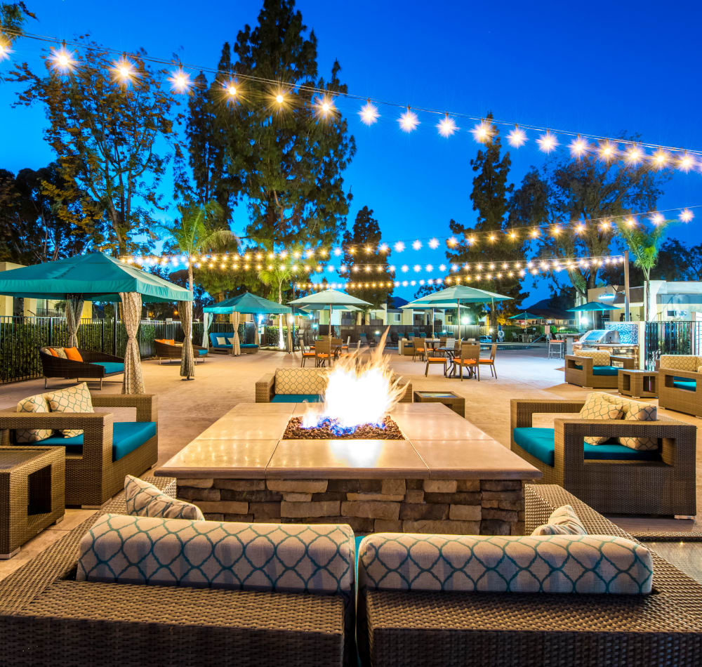 Beautifully designed outdoor common area with a fire pit and lounge at Sofi Poway in Poway, California