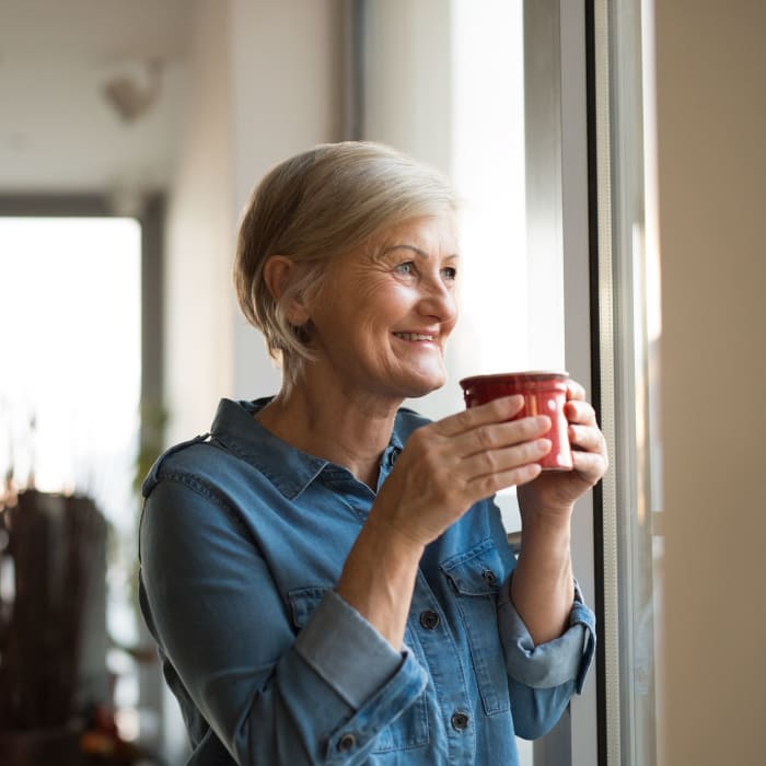 A resident enjoys a morning cup of coffee in her apartment at Alate Old Town, Alexandria, Virginia