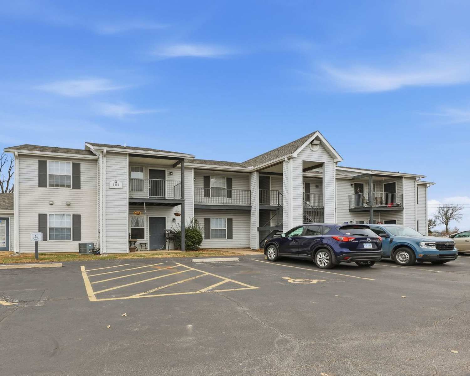 Exterior of the apartment building with car parking space at Parkford Apartments in Iola, Kansas