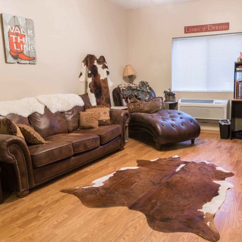 An apartment living room decorated with a western theme at Crown Point Apartments in Ames, Iowa