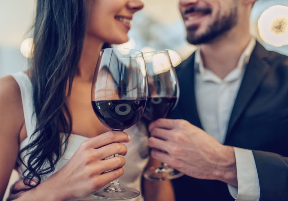 Couple raising a glass of wine to celebrate their decision to move to Sofi Ventura in Ventura, California