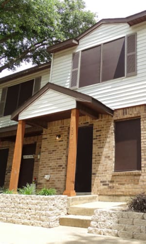 Covered front entryway to a townhome at Round Rock Townhomes in Arlington, Texas