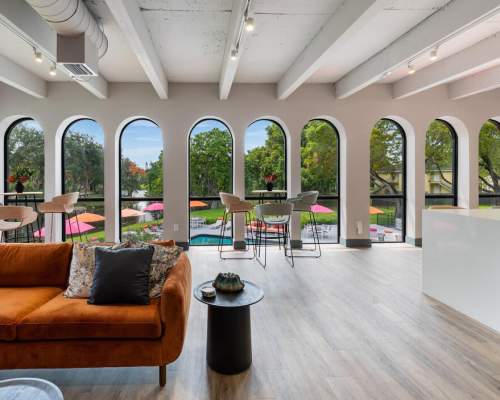 Clubhouse with large arching windows at Delamar Apartment Homes, Sunrise, Florida