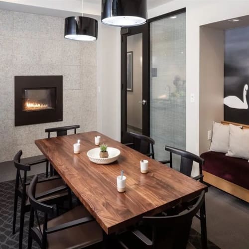 Dining table by a fireplace in the clubhouse at Foundry Lake Street in Minneapolis, Minnesota