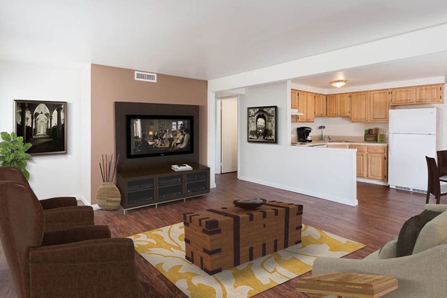 Spacious living room and kitchen of an open layout model home at Idylwood Resort Apartments in Cheektowaga, New York