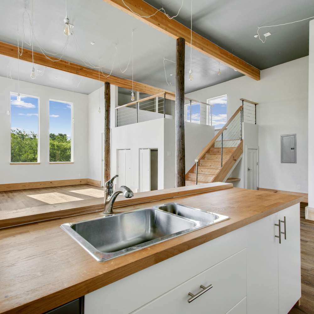 Kitchen with sink and wooden countertop at The Lofts at 305 in Bryan, Texas