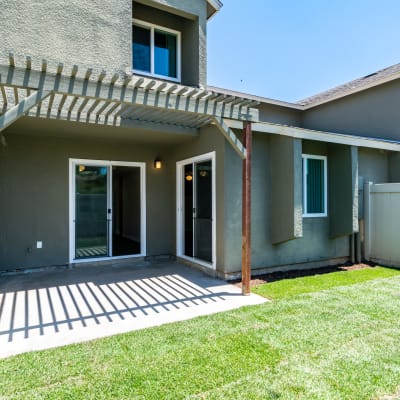 An enclosed backyard and lawn at a home at O'Neill Heights East in Oceanside, California