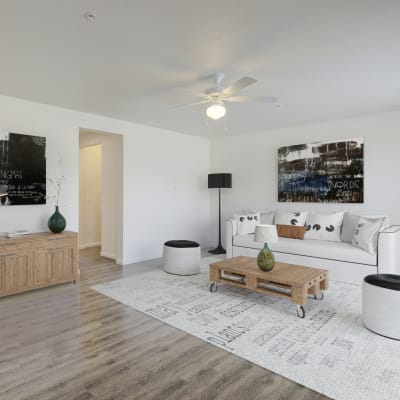 Living Room furnished with couches, chairs, side tables and a tv