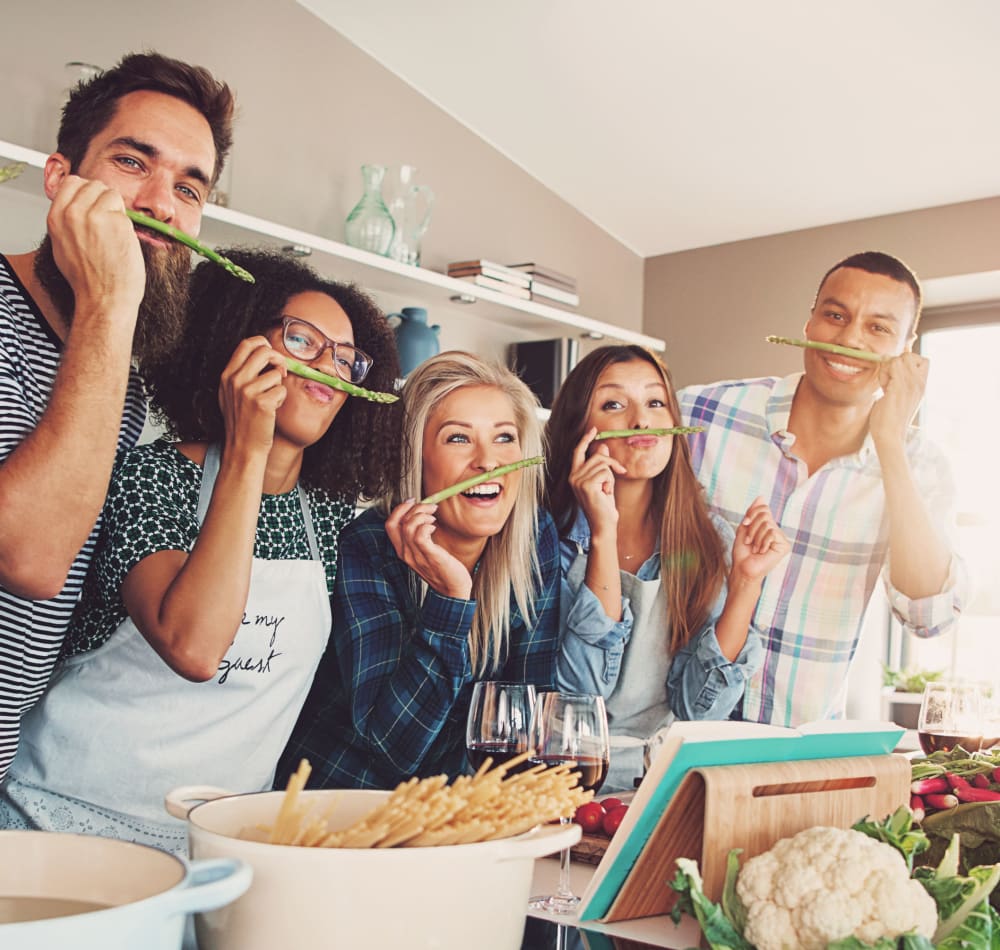 Friends cooking together at Haven Apartment Homes in Kent, Washington