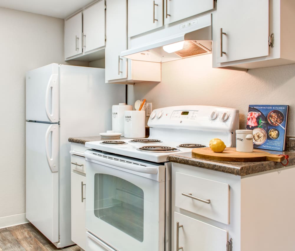 Modern kitchen with bright white appliances and ample cupboard space in a model home at Sofi Dublin in Dublin, California