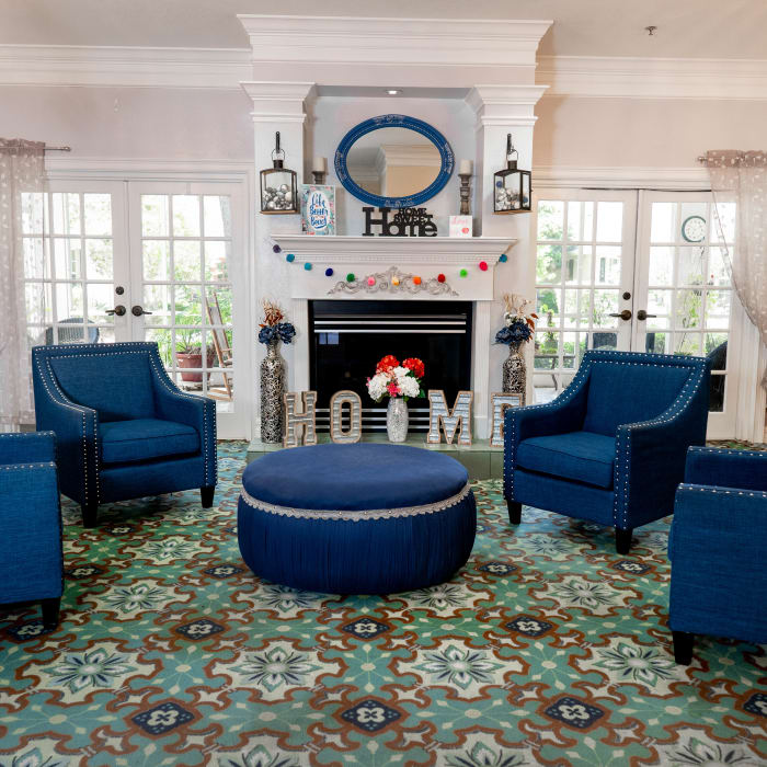 Community seating area and fireplace with large windows at The Club at Haines City in Haines City, Florida