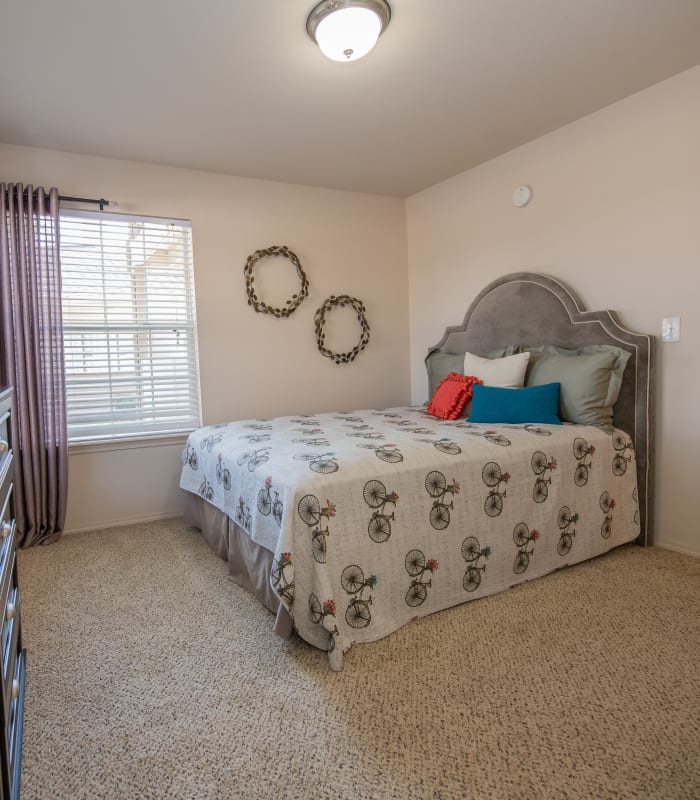 Spacious carpeted bedroom at Remington Apartments in Amarillo, Texas