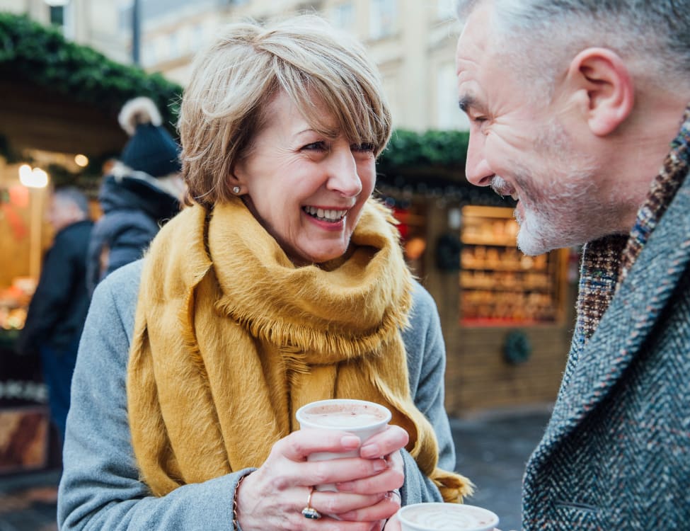 Couple drinking a cup of coffee near North Square Apartments at The Mill District in Amherst, Massachusetts