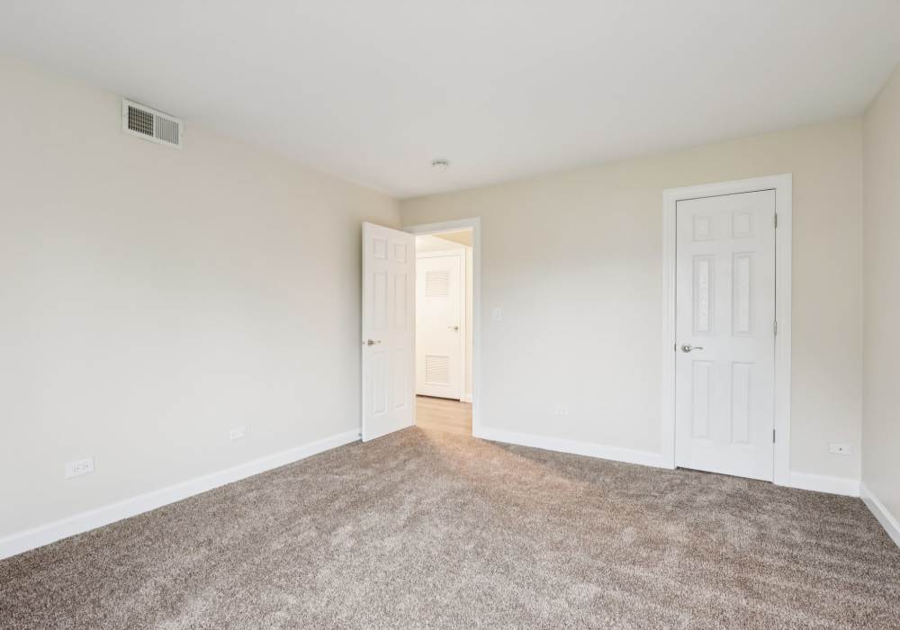 Unfurnished bedroom with carpet flooring at Crystal Lake Apartments in Crystal Lake, Illinois