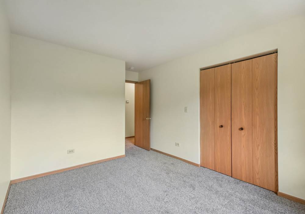 Unfurnished bedroom with carpet flooring at Maple Leaf Apartments in Merrillville, Indiana