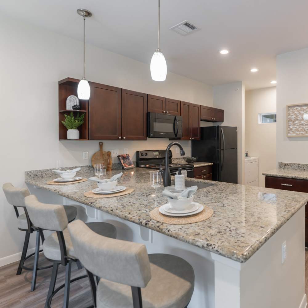 Granite countertops and the breakfast bar in the kitchen at Regency Gardens in Bryan, Texas