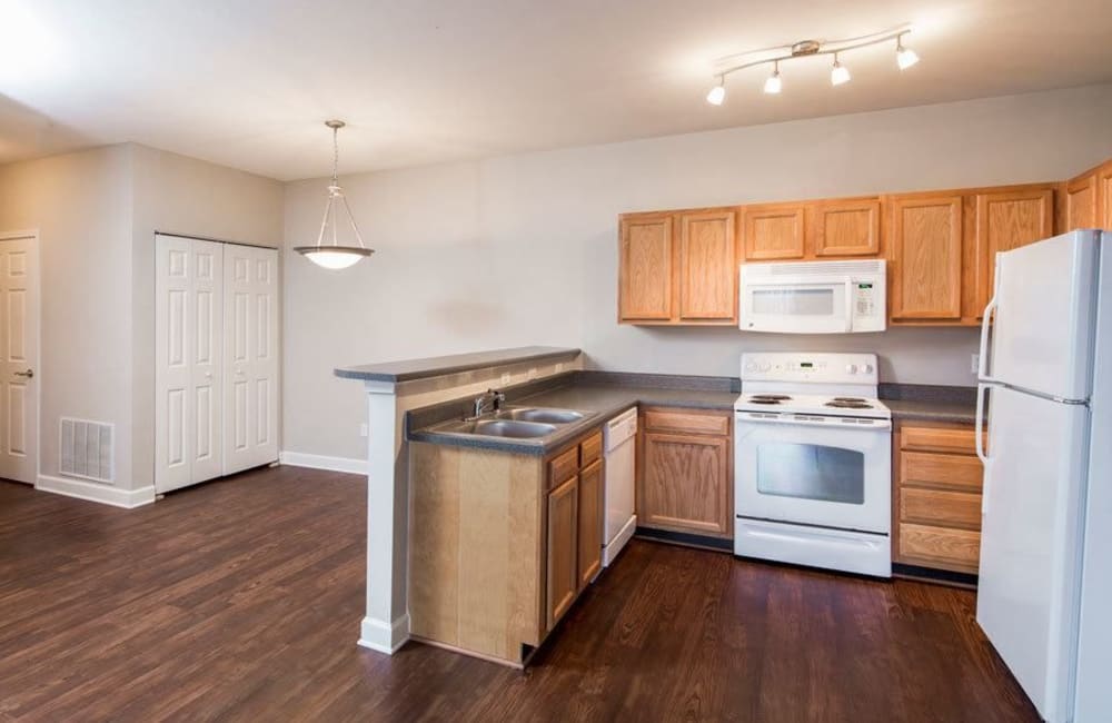 Kitchen and dining area of home with hardwood flooring at Crescent at Wolfchase in Memphis, Tennessee