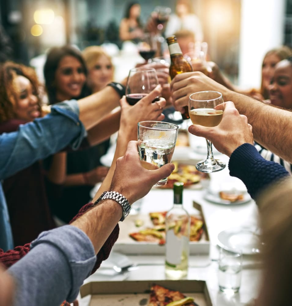 Group of resident friends out for a meal at their favorite restaurant and raising a toast to the good life at Verse Seattle in Seattle, Washington