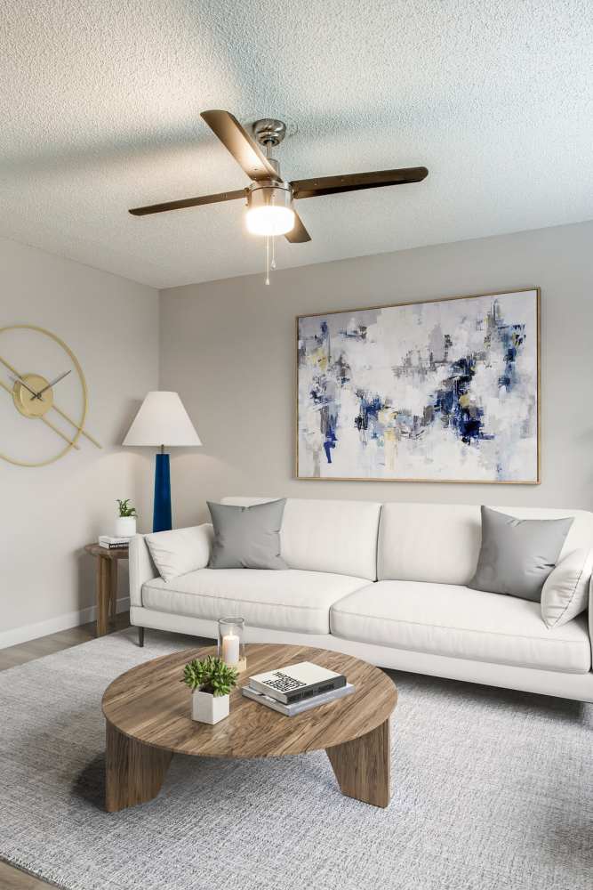 Living room with couch and wood-style flooring at Villa De Oro in San Antonio, Texas