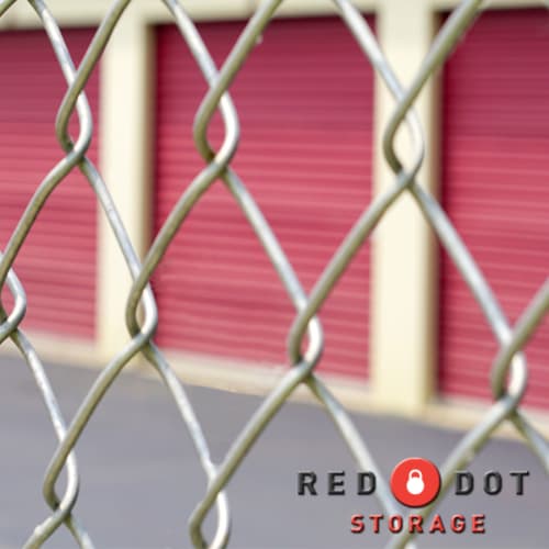 Chain link fence in front of climate-controlled storage units at Red Dot Storage in Rockford, Illinois