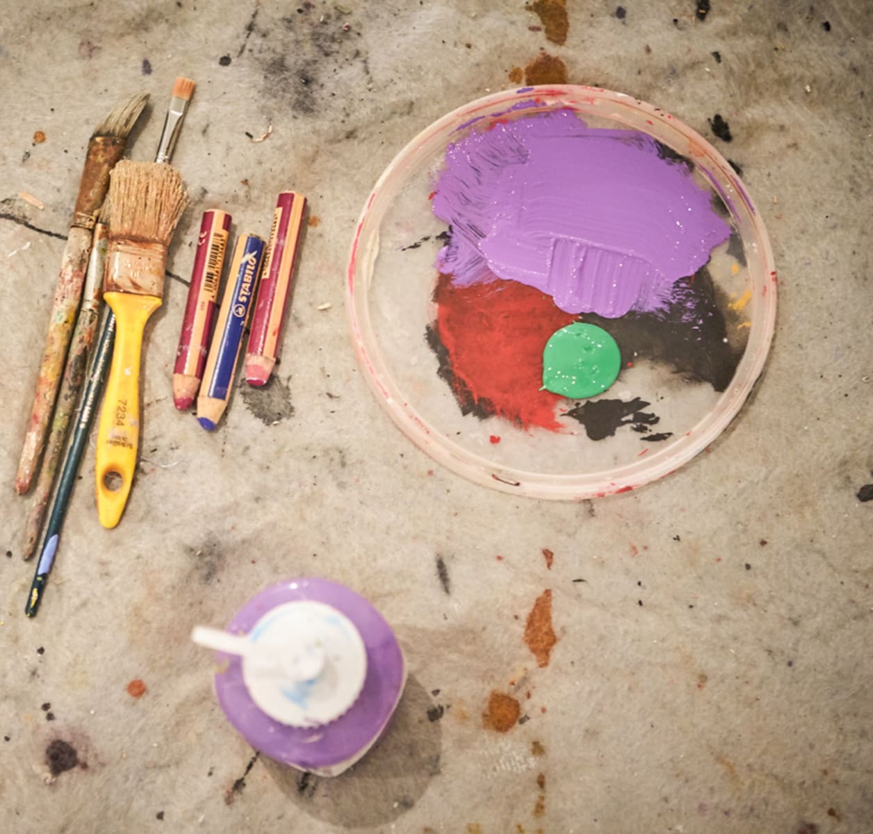 Colors and brushes on a workspace, creative and inspiring.