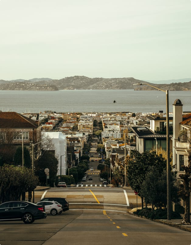 A San Francisco street sloping down toward the bay at golden hour
