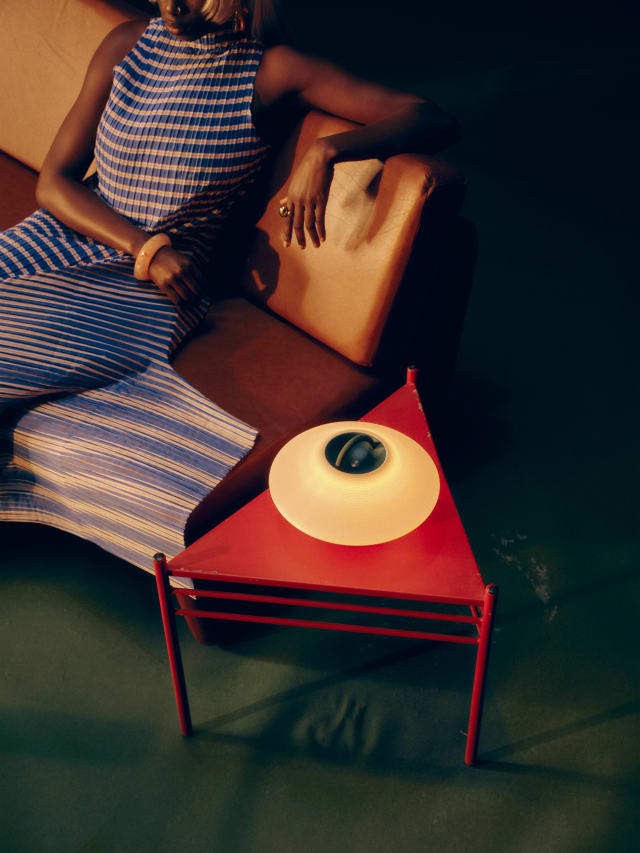 Eave Low lamp resting on a side table at home, fully powered.