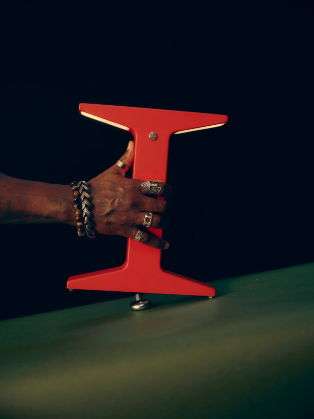 Hand placing the Drift lamp back on its Charging Base.