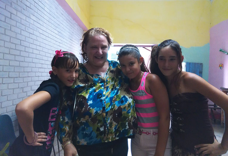 Volunteer teacher with local students in Cuba
