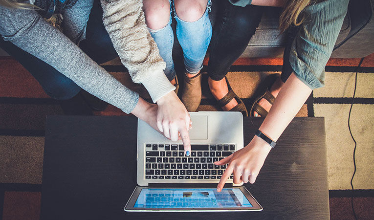 Girls pointing at laptop